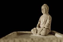 gallery-3 Serene Buddha statue sitting in zen meditation on fine sand, embodying tranquility.