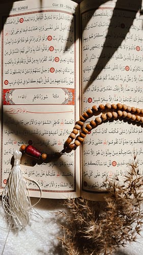 gallery-1 Holy Quran open with prayer beads in sunlight, Islamic spirituality focus.